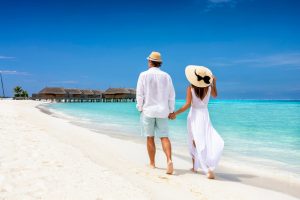 Happy,Couple,In,White,Clothing,And,With,Hats,Walks,Down